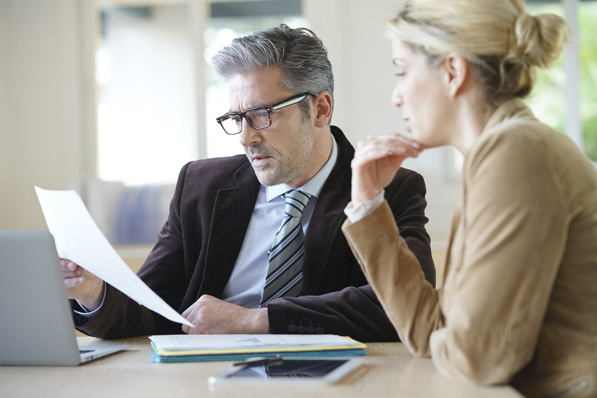 A man goes through some documents with a woman