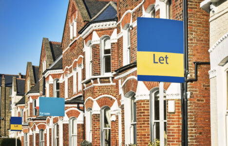 UK street with terraced houses and signs