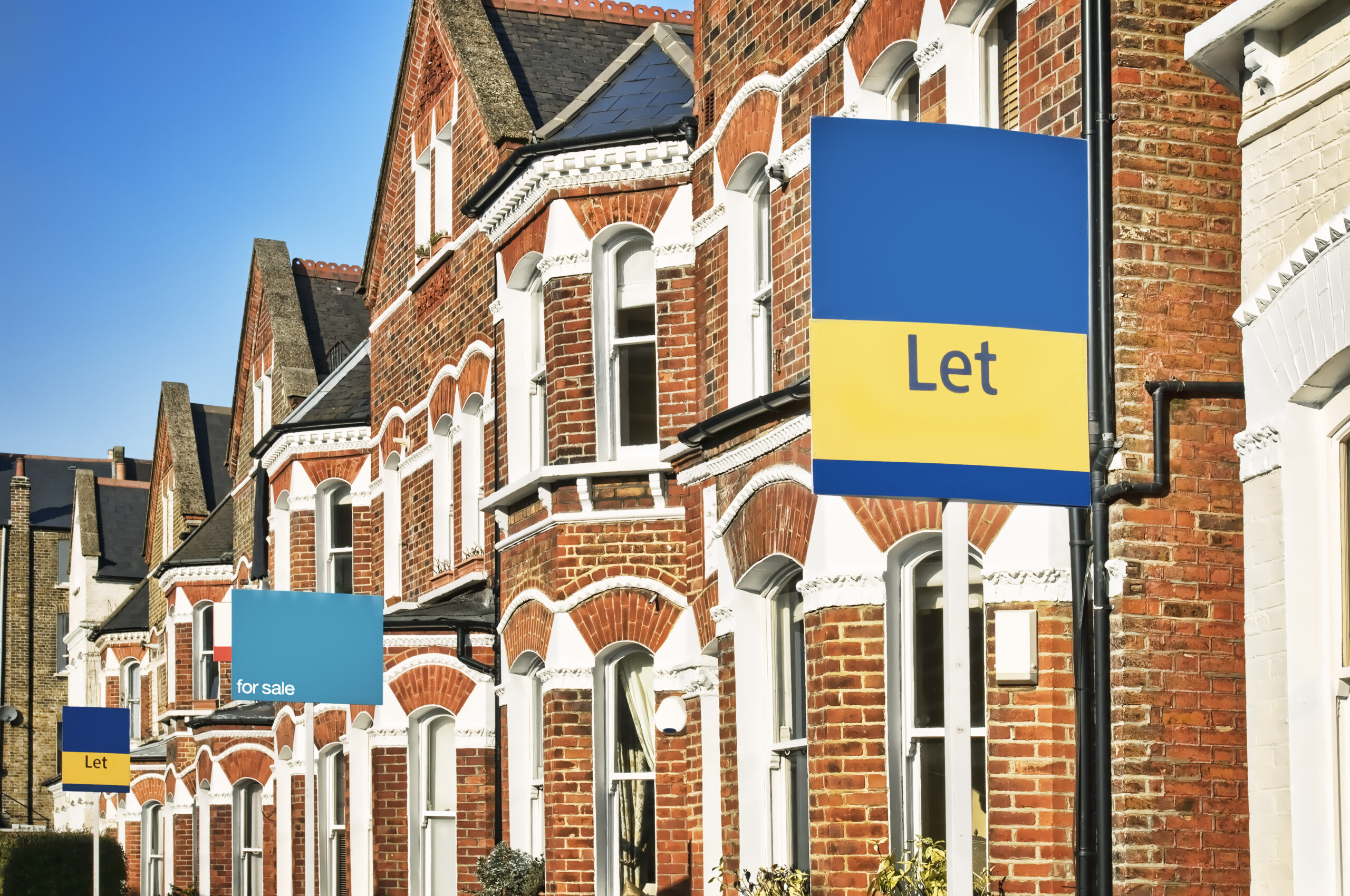UK street with terraced houses and signs