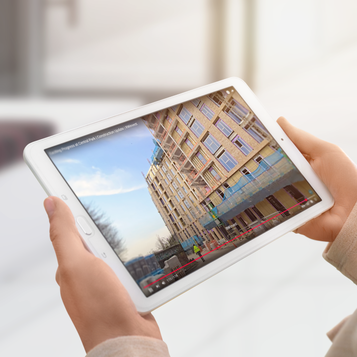 Mockup showing hands holding a tablet with a video playing on YouTube