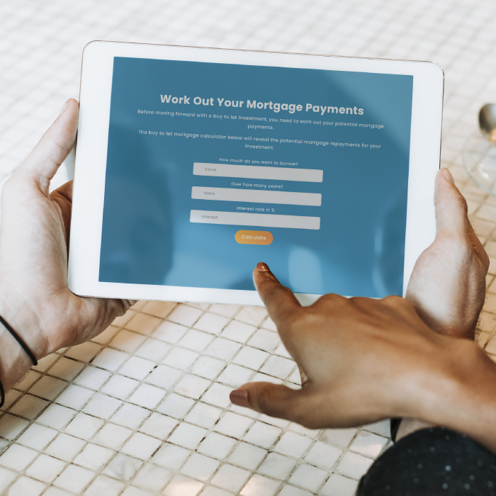 Mockup image showing hands holding a tablet with RWinvest's mortgage calculator on it