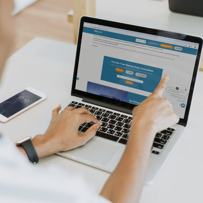 Mockup of person using a laptop that shows RWinvest's stamp duty calculator page