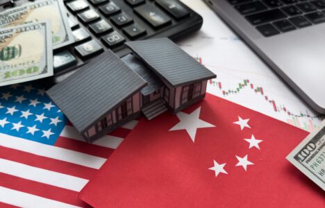 Trumo Trade War - US and China flag with house figure and calculator