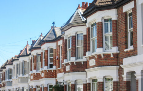 Row of terraced houses in the UK, with blue sky