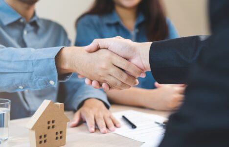 two person shaking hands over a real estate deal