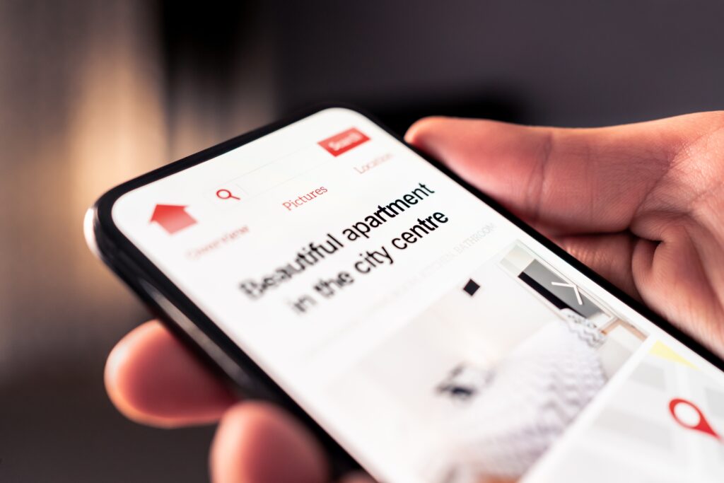 Person browsing short-term let apartments on their phone