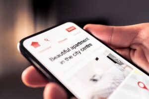 Person browsing short-term let apartments on their phone