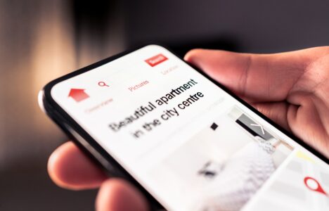 Person browsing short-term let apartments on their phone