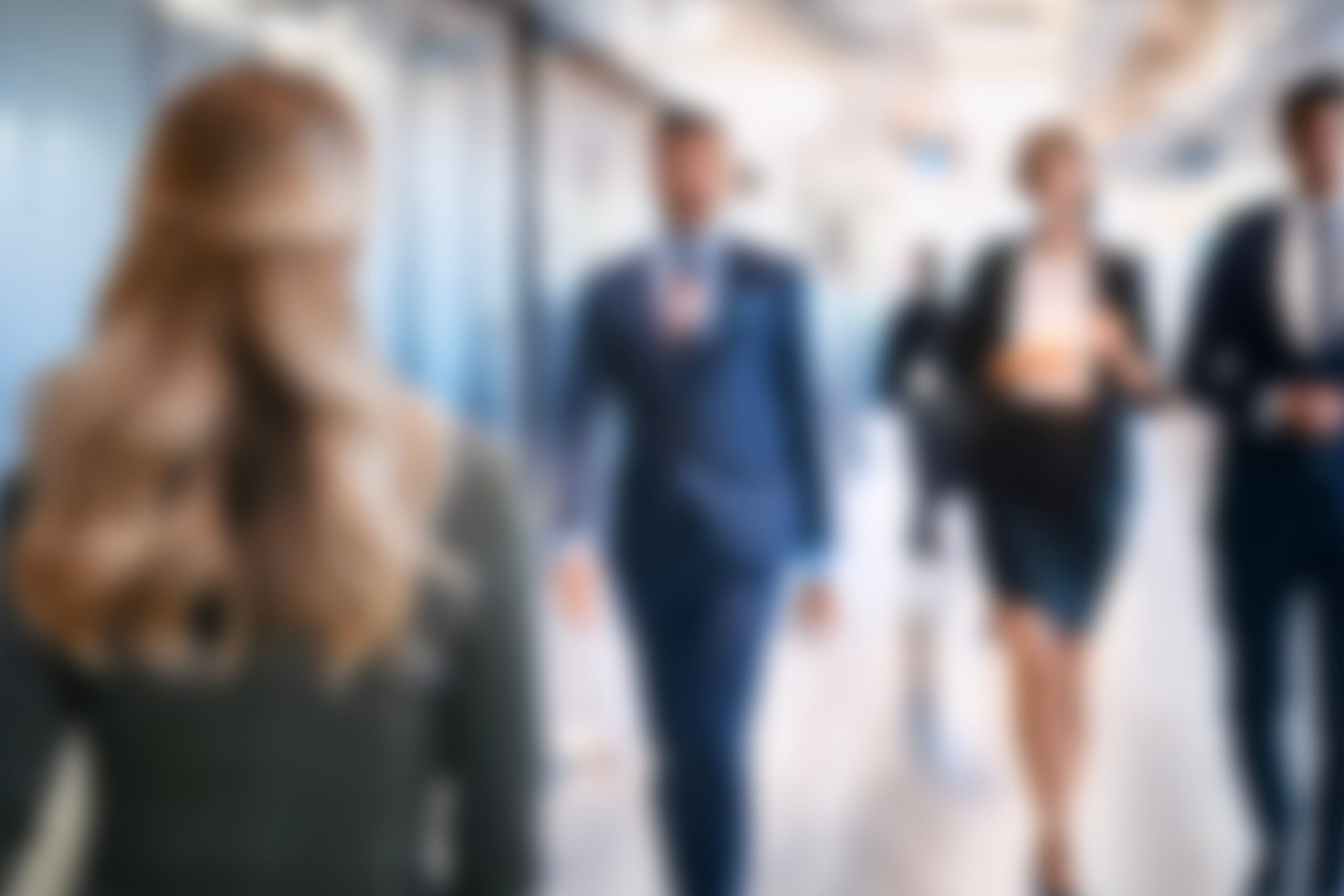 Blurred image of business people walking through office