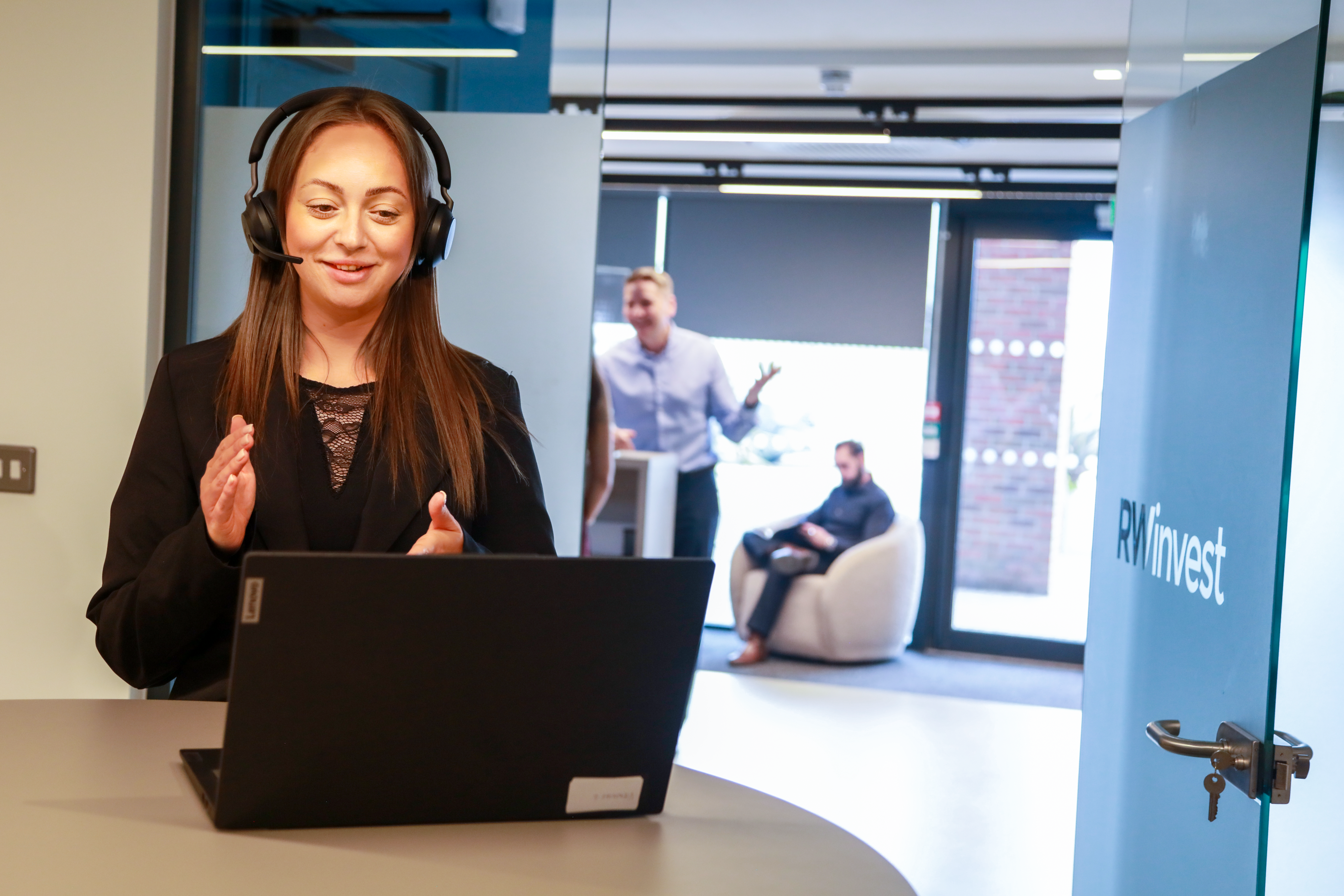 RWinvest Liverpool office photo - team member talking on headset