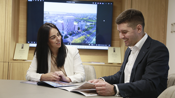 Liverpool office at RWinvest - staff members chatting and looking at brochure