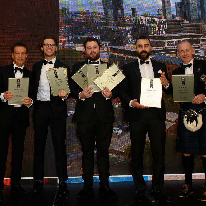 RWinvest team on stage with awards at International Property Awards